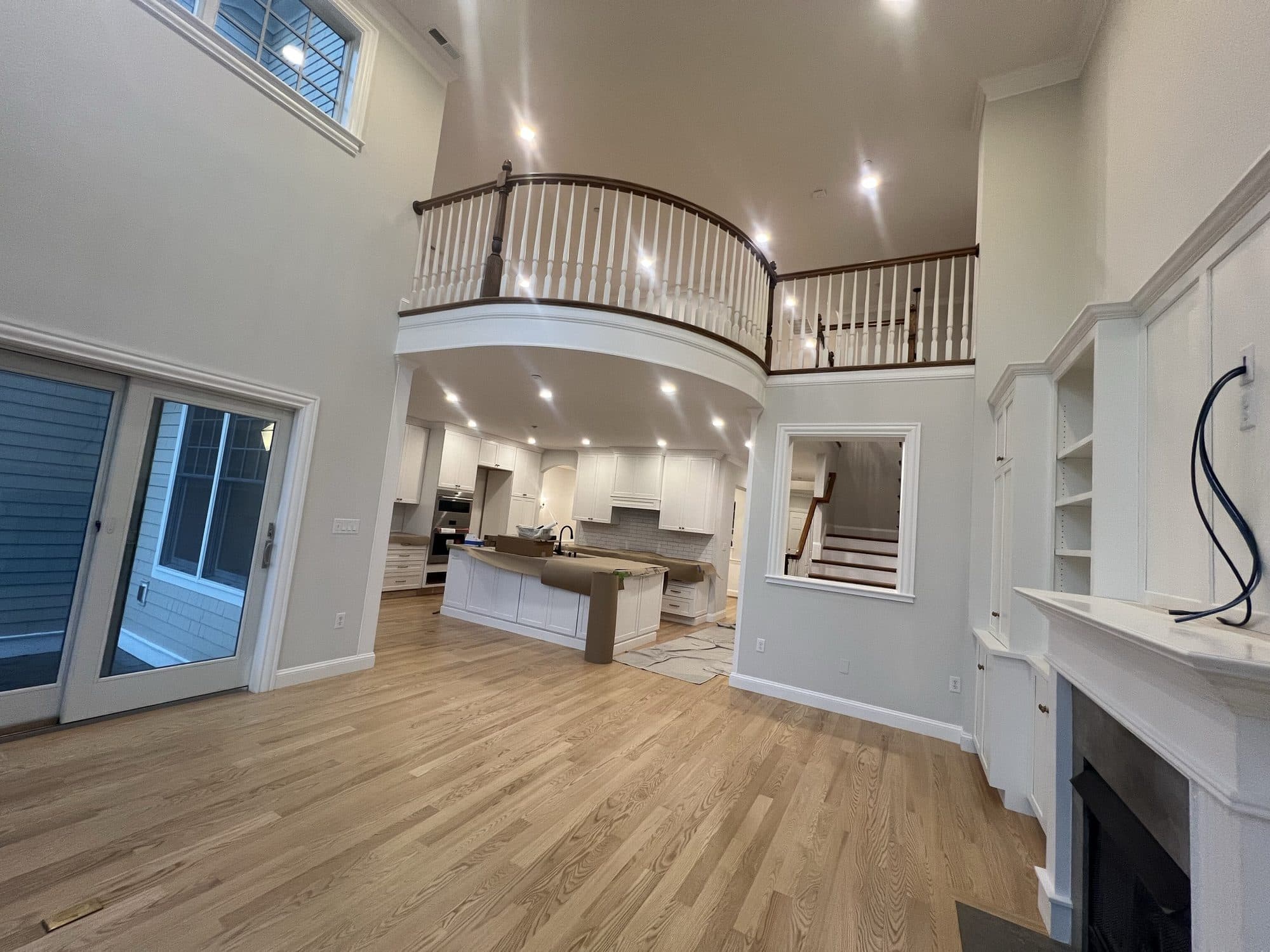 Two-story great room with a balcony overlook and open kitchen